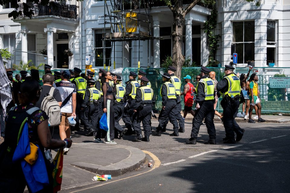 a group of police officers are walking down the street