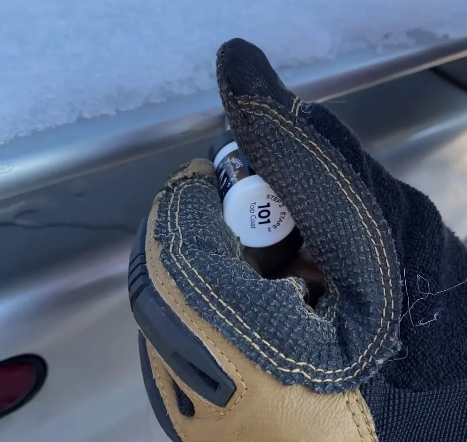 a person wearing a glove with the word tool on it