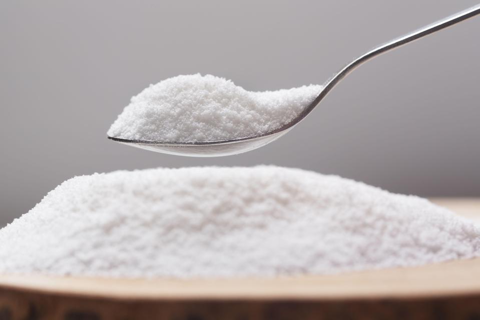 a spoonful of salt is being poured into a pile of salt