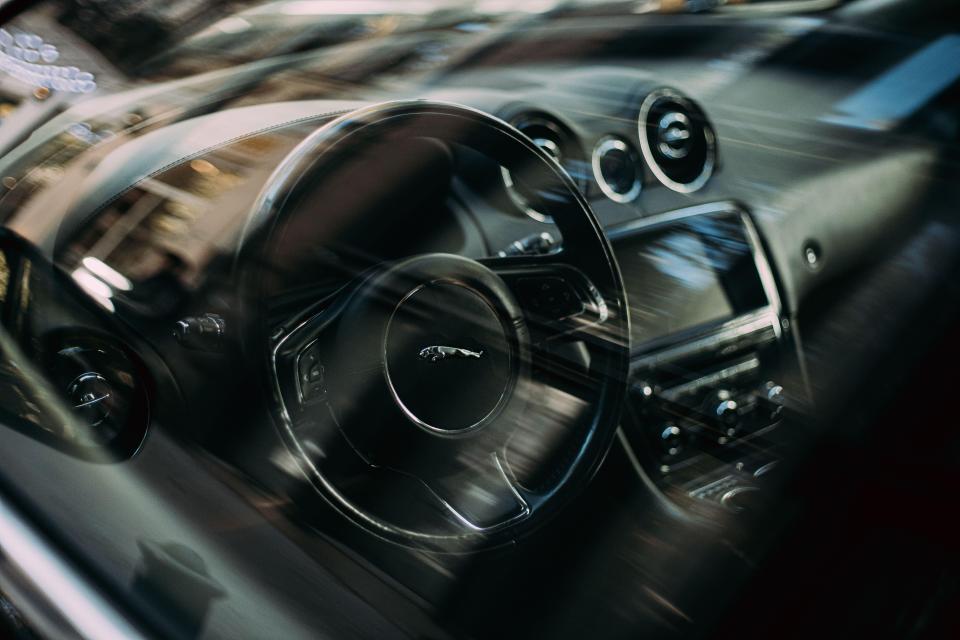 the inside of a car with a jaguar logo on the steering wheel