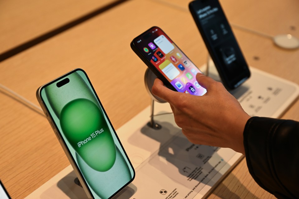 PALO ALTO, CALIFORNIA - SEPTEMBER 22: Customers check new iPhone 15s up as people lined up to buy the newly launched iPhone 15 and other Apple products outside of the Apple store in Palo Alto, California, United States on September 22, 2023. (Photo by Tayfun Coskun/Anadolu Agency via Getty Images)