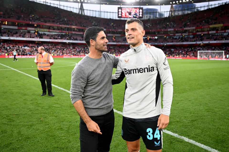 LONDON, ENGLAND - AUGUST 07: Mikel Arteta, Manager of Arsenal, interacts with Granit Xhaka of Bayer 04 Leverkusen following the pre-season friendly match between Arsenal and Bayer 04 Leverkusen at Emirates Stadium on August 07, 2024 in London, England. (Photo by Stuart MacFarlane/Arsenal FC via Getty Images)