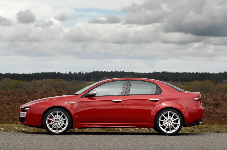 a red alfa romeo is parked on a white background