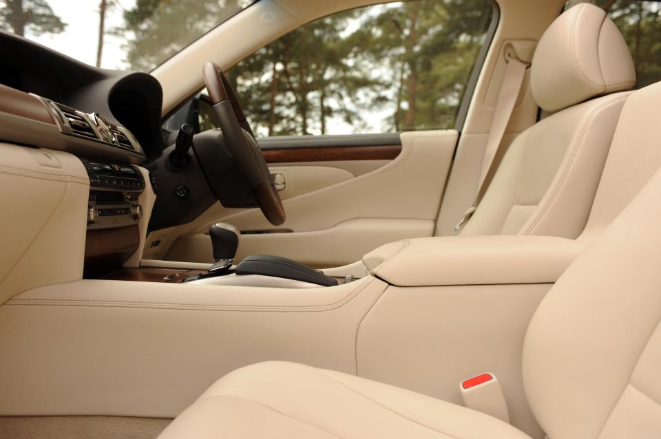 the interior of a car with white leather seats