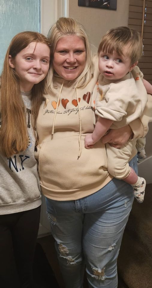a woman wearing a hoodie that says justice for every girl and child