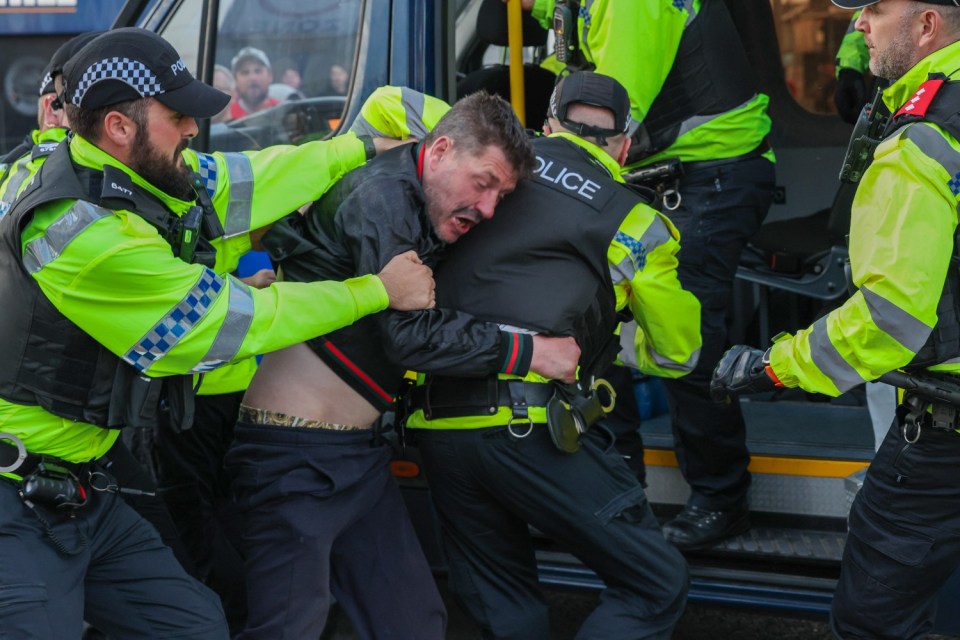 Police officers detain a person during an anti-immigration protest in Blackpool. Picture date: Wednesday August 7, 2024. PA Photo. See PA story POLICE Southport. Photo credit should read: PA Wire