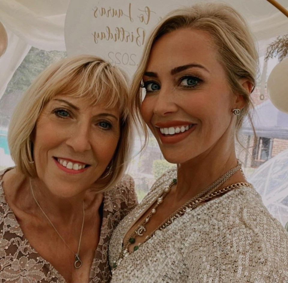 two women posing for a picture in front of a sign that says ssos