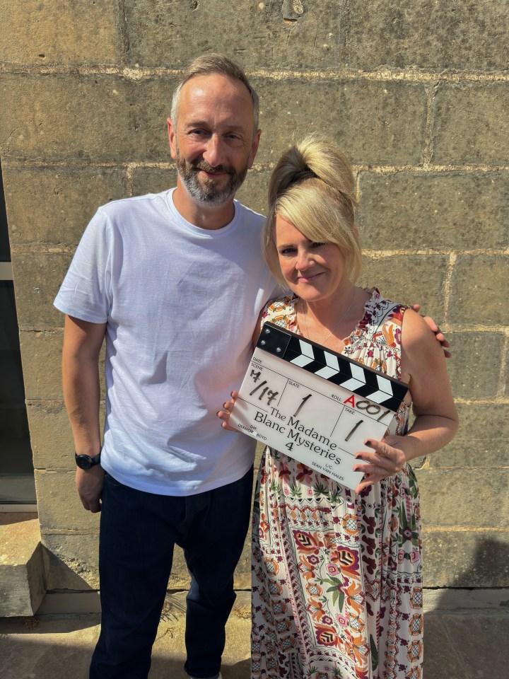 a man and woman holding a clapper board that says the madame blanc mysteries