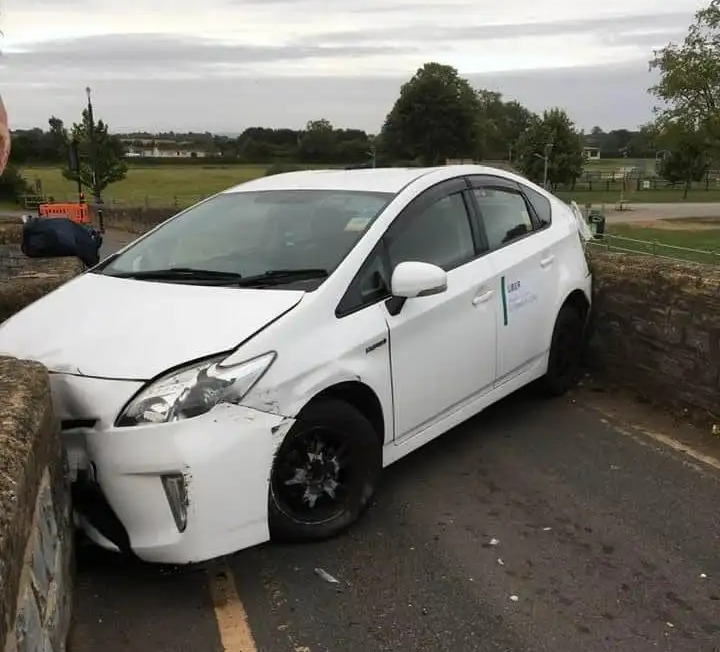 a white prius with a sign on the side that says ' toyota '