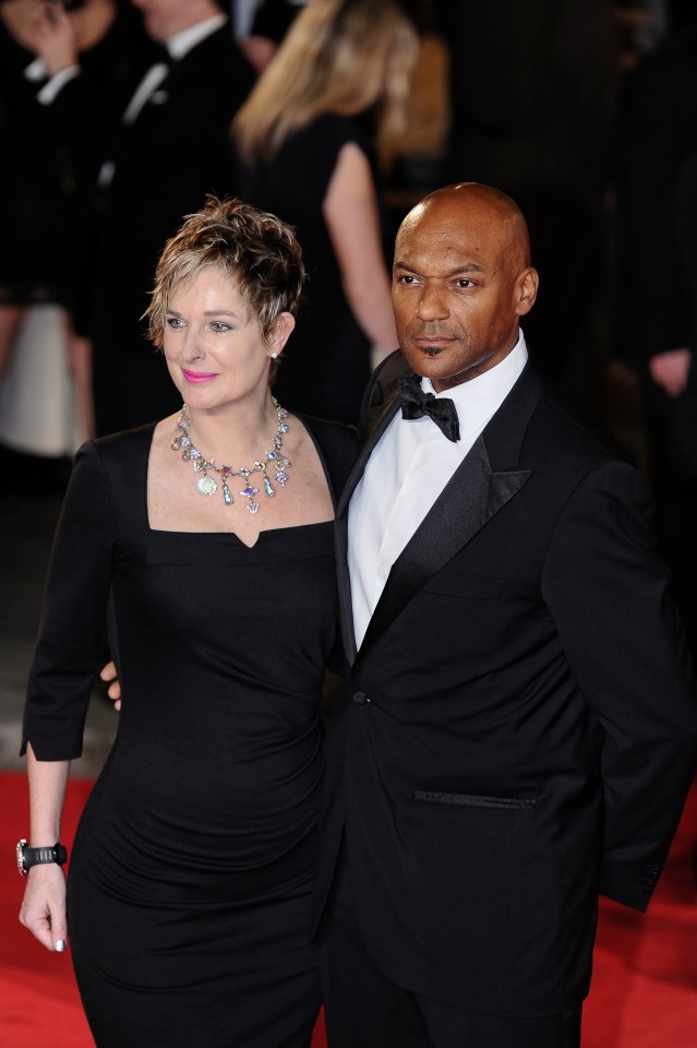 a man and woman are posing for a picture on a red carpet