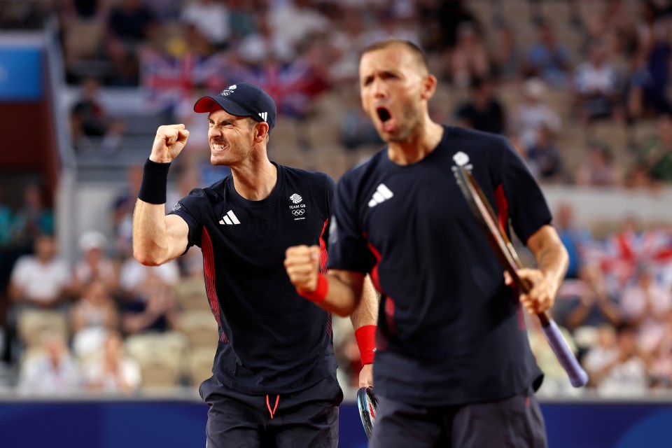 two men wearing adidas shirts are celebrating on a tennis court