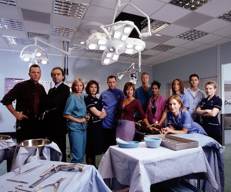 a group of doctors and nurses pose in an operating room