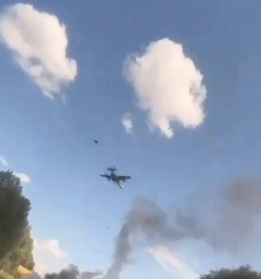 a plane is flying through a cloudy blue sky .