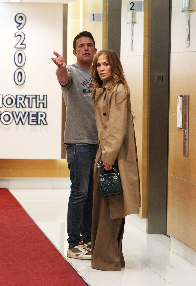 a man and woman standing in front of a sign that says north tower