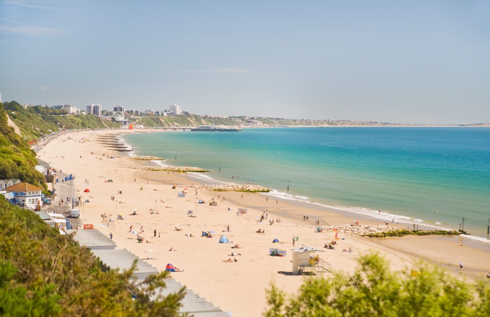 a beach with a lifeguard tower in the foreground