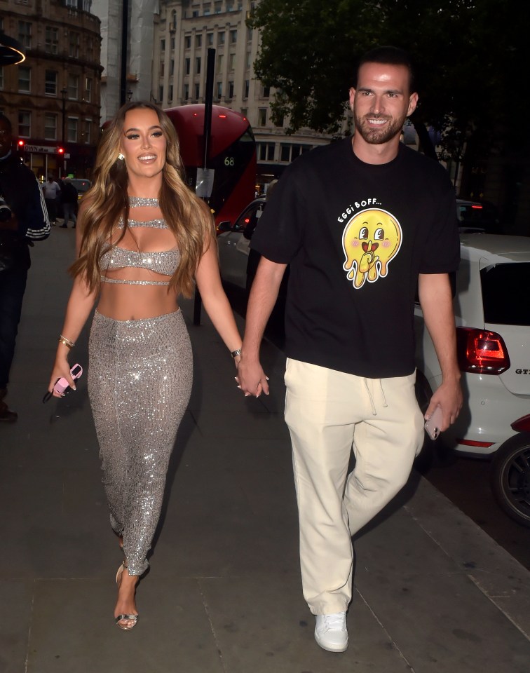 a man wearing a t-shirt that says feel borf walks with a woman