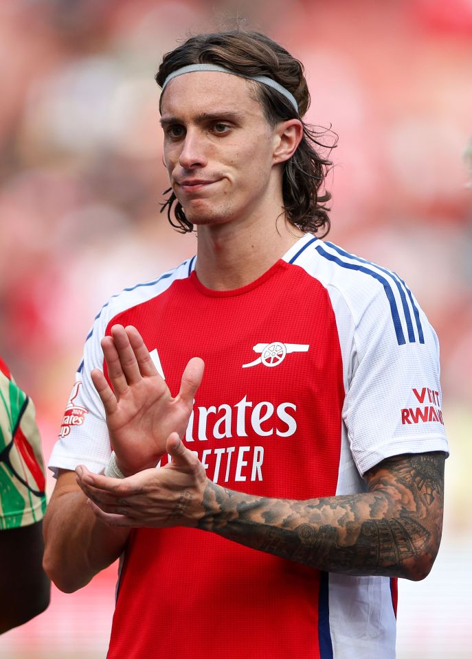 a soccer player wearing a red shirt that says emirates better