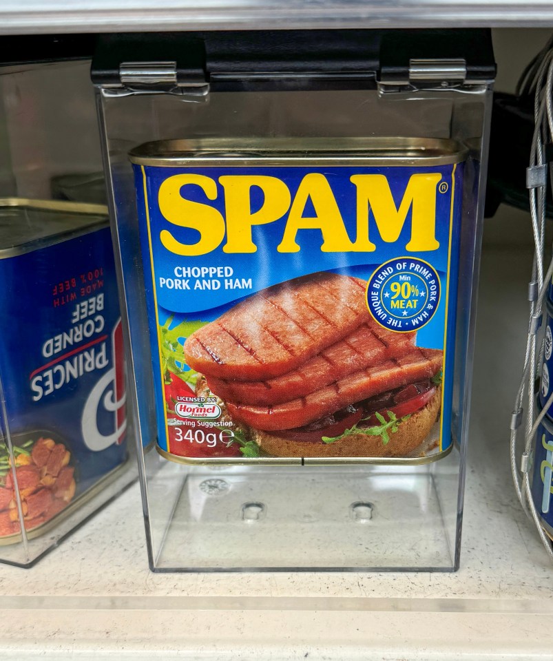 a can of spam sits on a store shelf