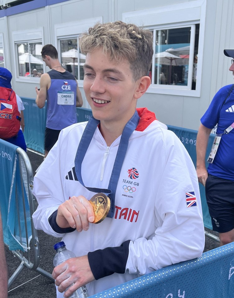 a boy with a medal around his neck that says team gb on it