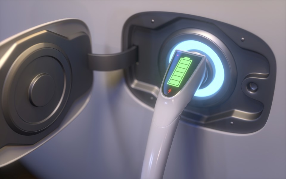 an electric car is plugged into a charging station
