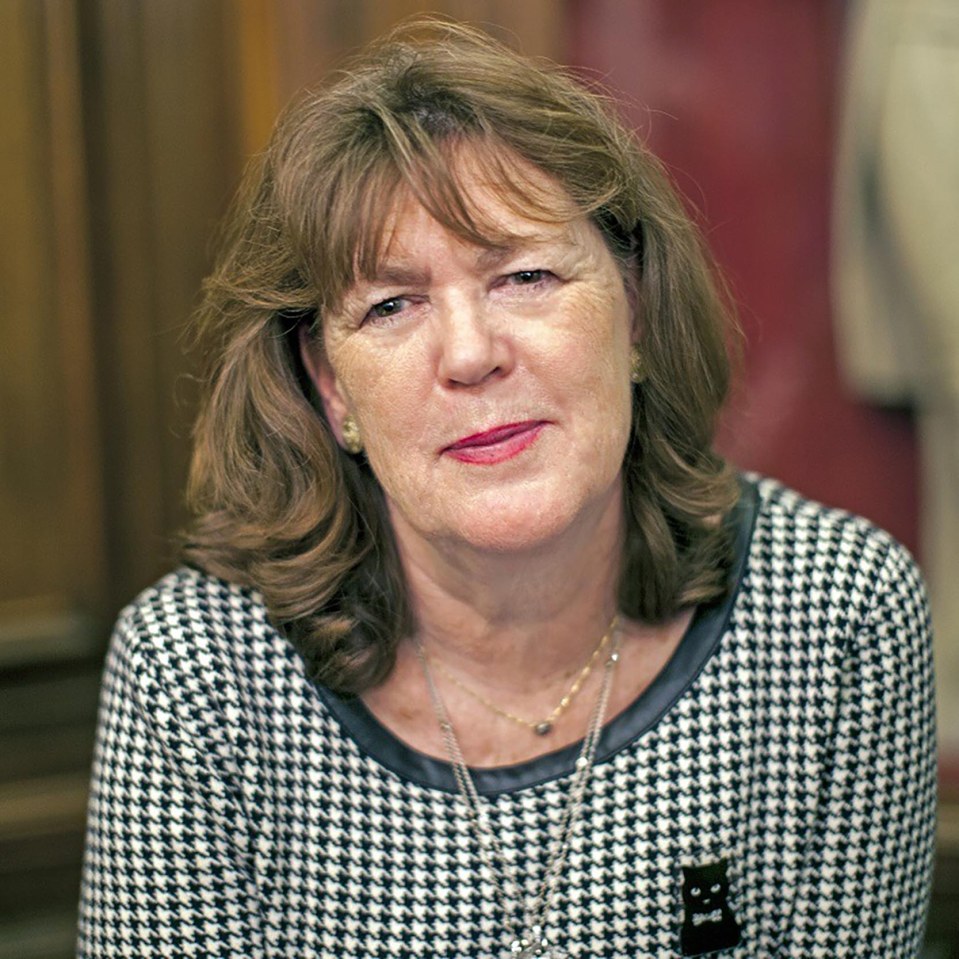 a woman wearing a black and white houndstooth shirt with a cat collar