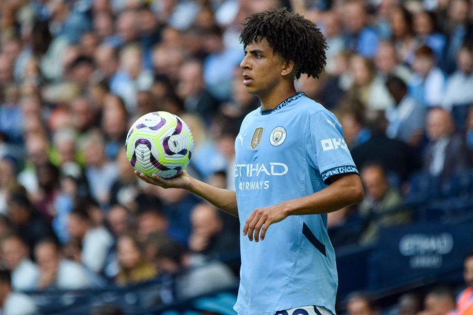 a soccer player holding a soccer ball that says etihad airways