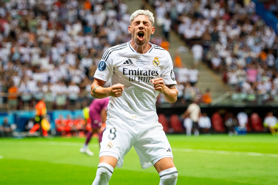 a soccer player wearing a jersey that says emirates fly better