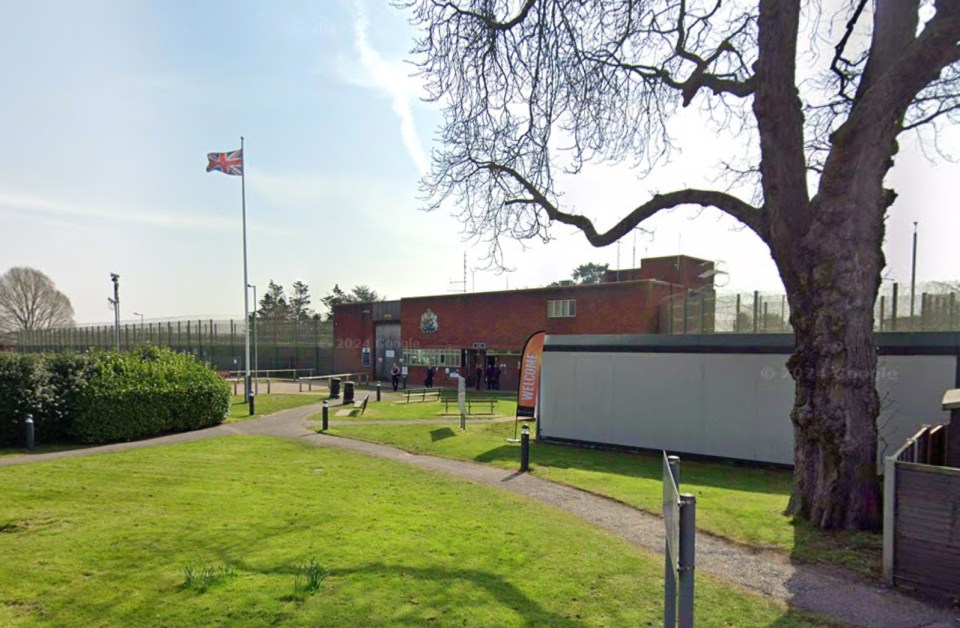 a british flag is flying in front of a prison