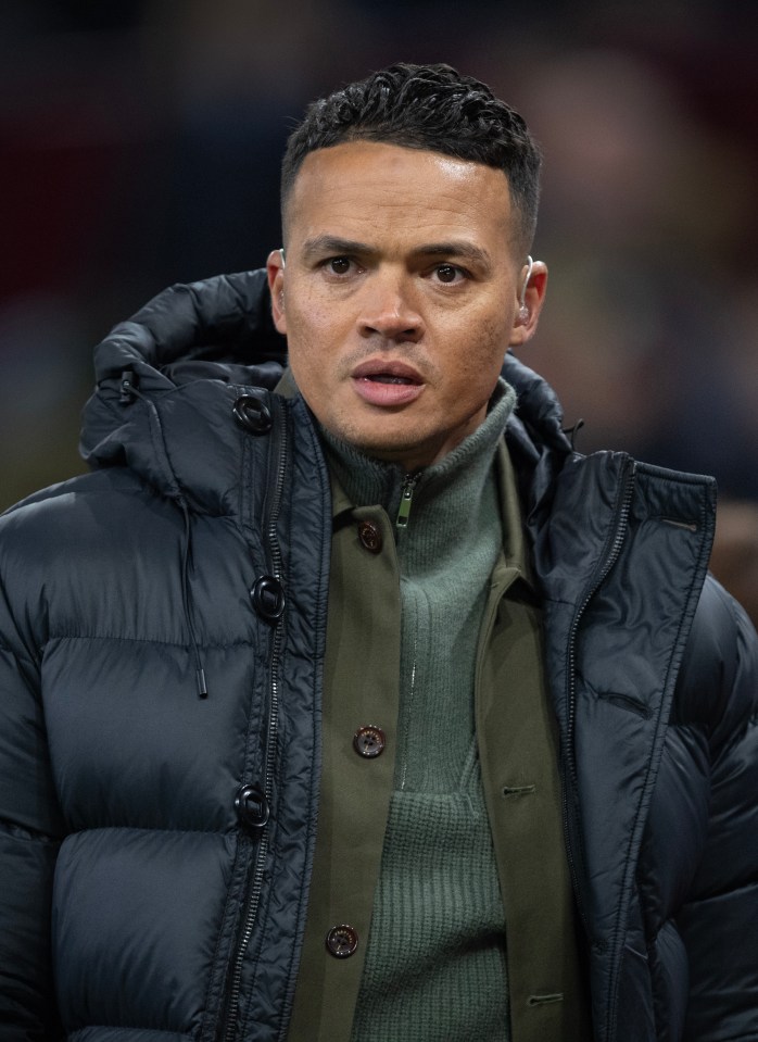 a man wearing a black jacket with a hood