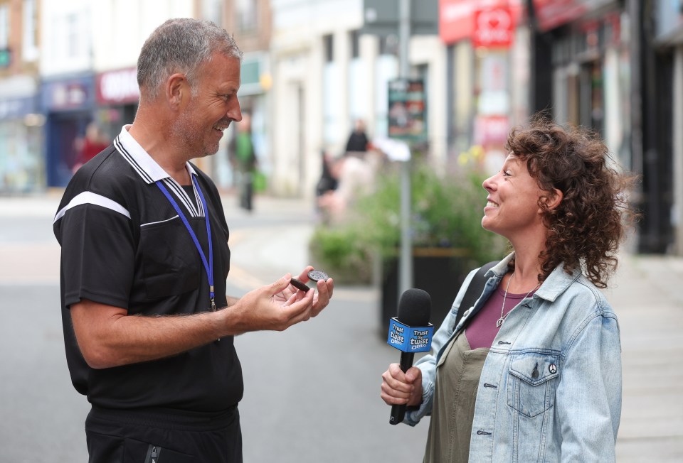 a man is talking to a woman who is wearing a microphone that says bbc radio