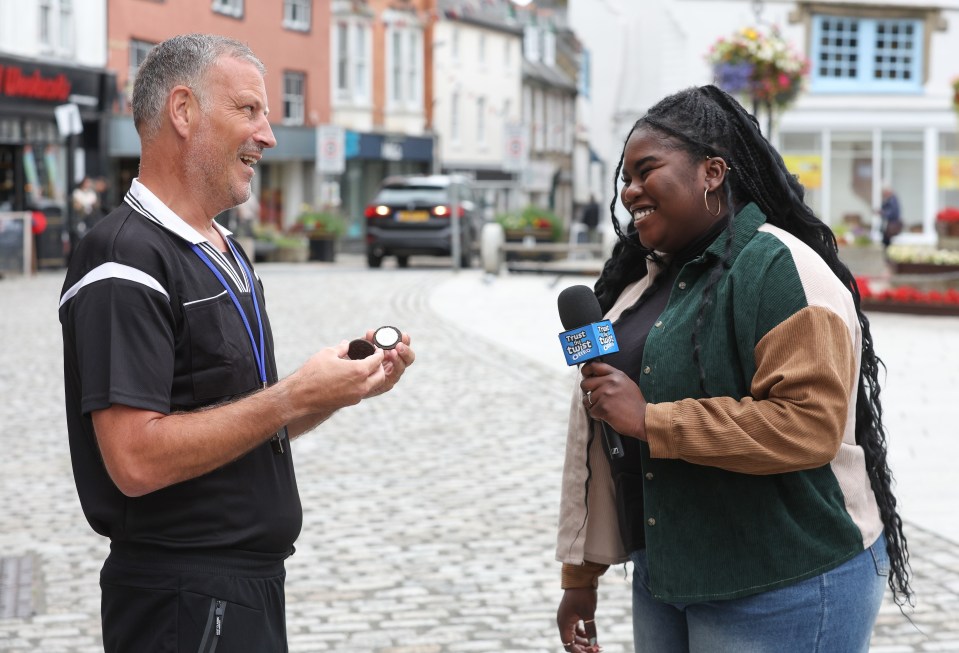a woman holding a microphone that says bbc on it