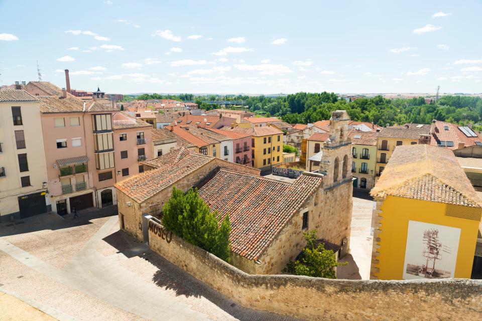an aerial view of a city with a yellow building in the middle
