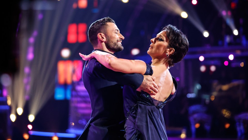a man and a woman are dancing together on a stage