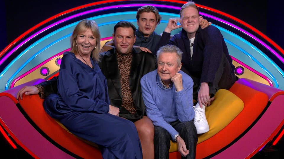 a group of people posing for a picture on a colorful couch