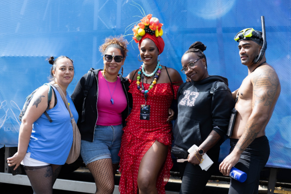 a group of people posing for a picture in front of a lounge sign
