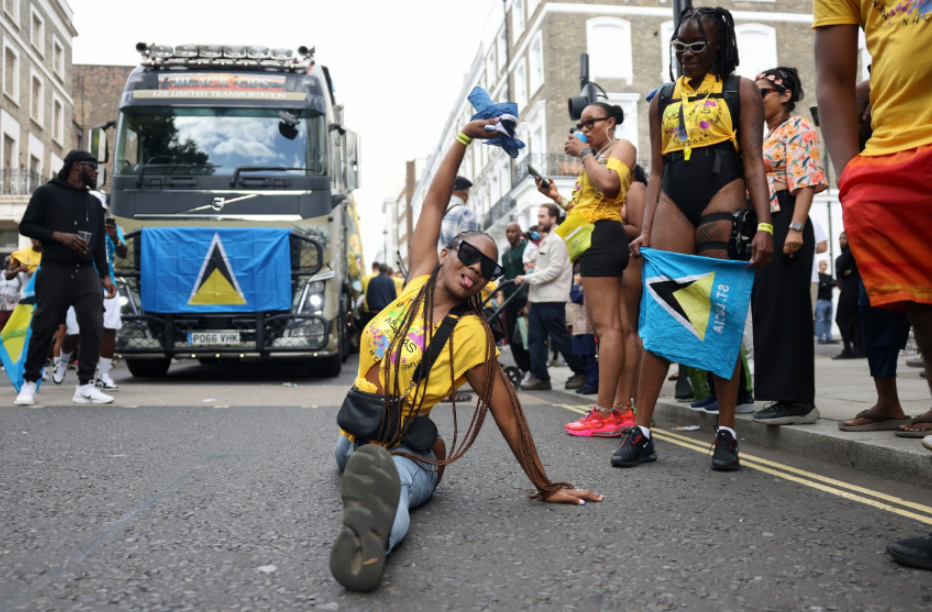 a woman is kneeling on the street in front of a truck that says volvo on the top