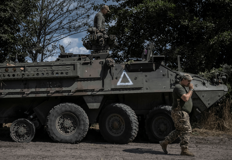 a military vehicle has a white triangle on the side