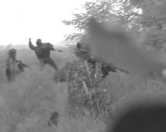 a black and white photo of soldiers in a field
