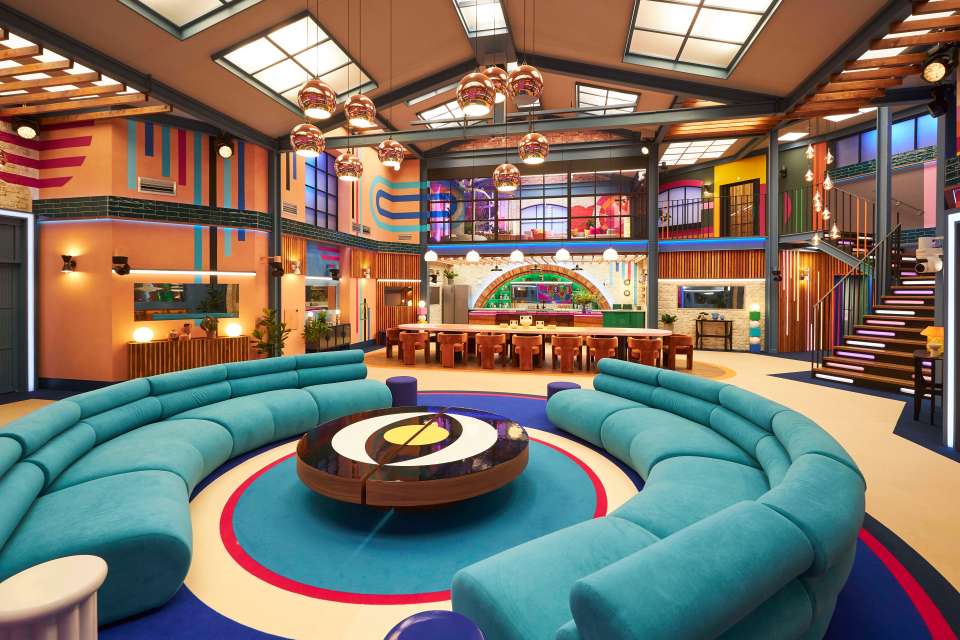 a living room with a blue couch and a round coffee table