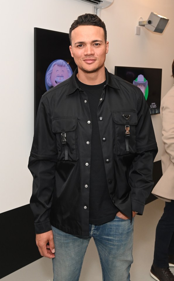 a man wearing a black shirt with the word prada on it