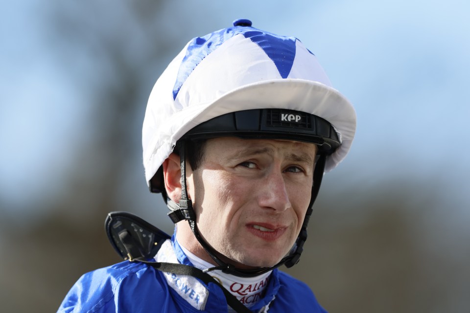 a jockey wearing a helmet that says kpp on it