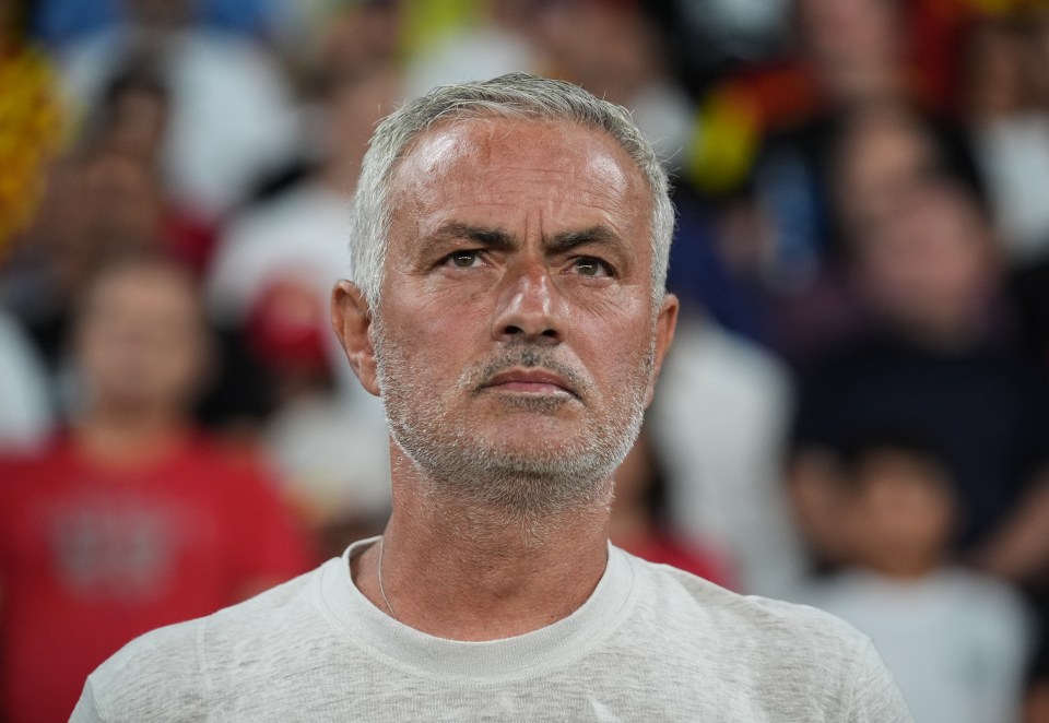 a man with gray hair and a beard looks at the camera