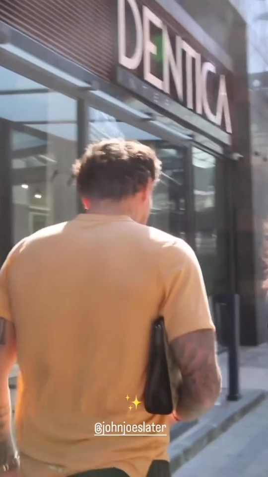 a man walking in front of a dentica store