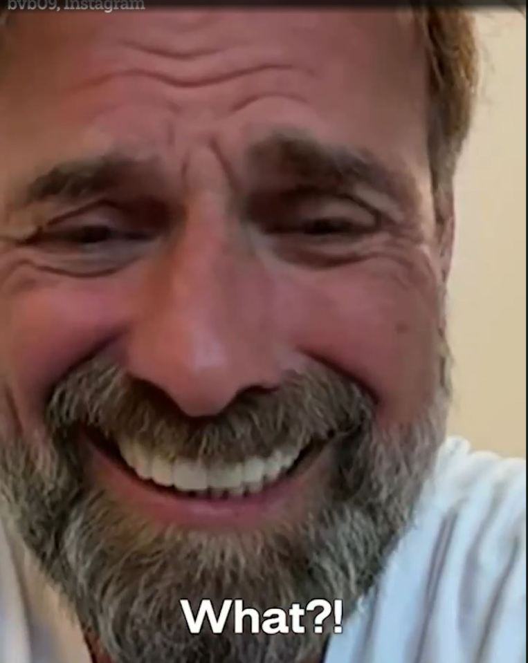 a man with a beard is smiling and saying what