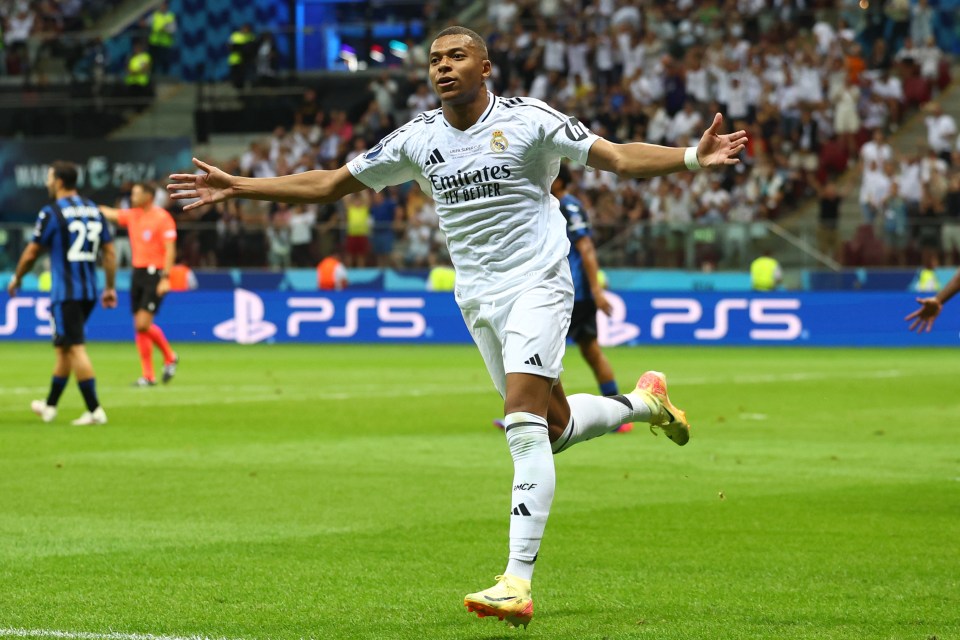 a soccer player wearing a jersey that says emirates fly better