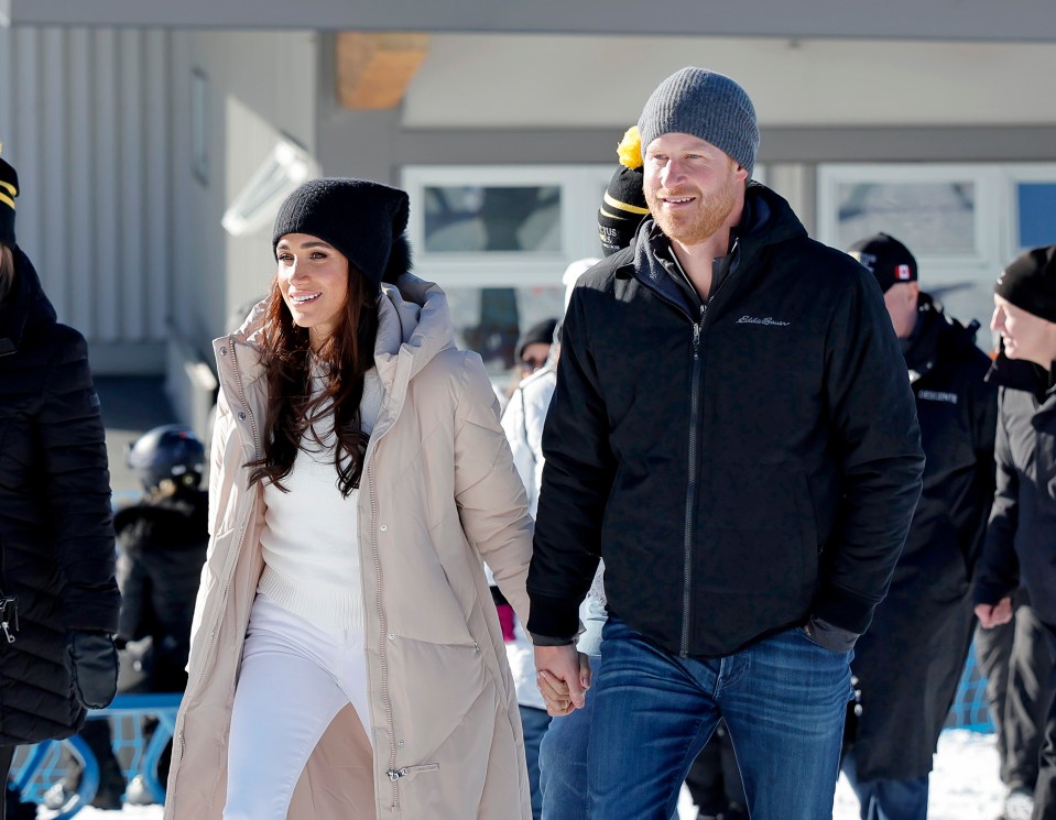 prince harry and meghan markle holding hands in the snow