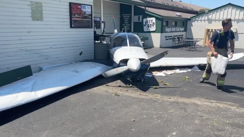 a plane has crashed in front of a building that says key word