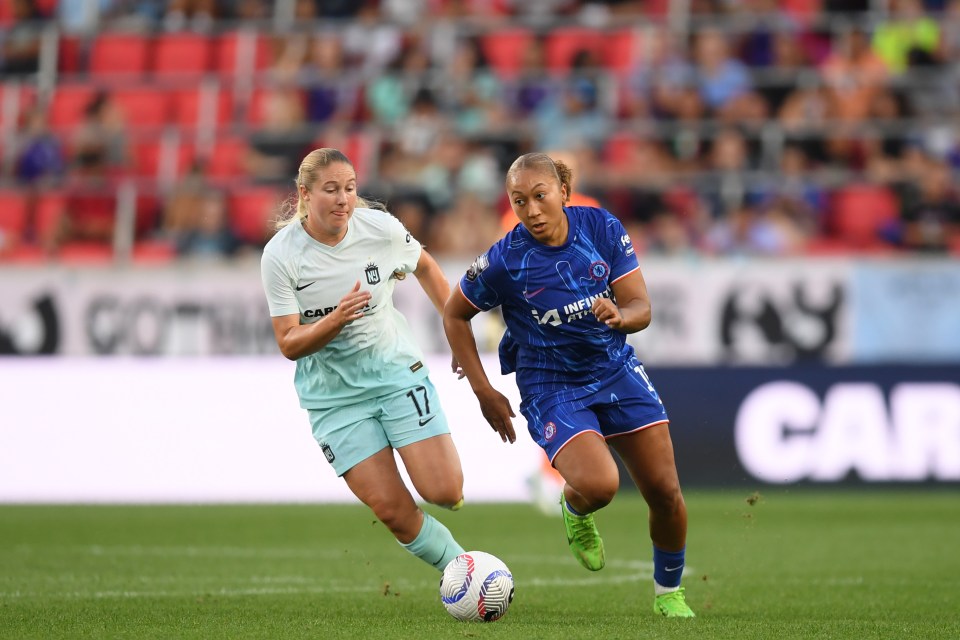 two female soccer players on a field with one wearing number 17