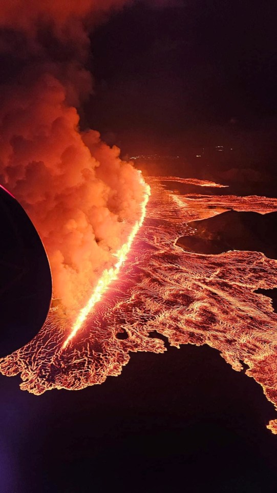 an artist 's impression of a volcano erupting into the ocean