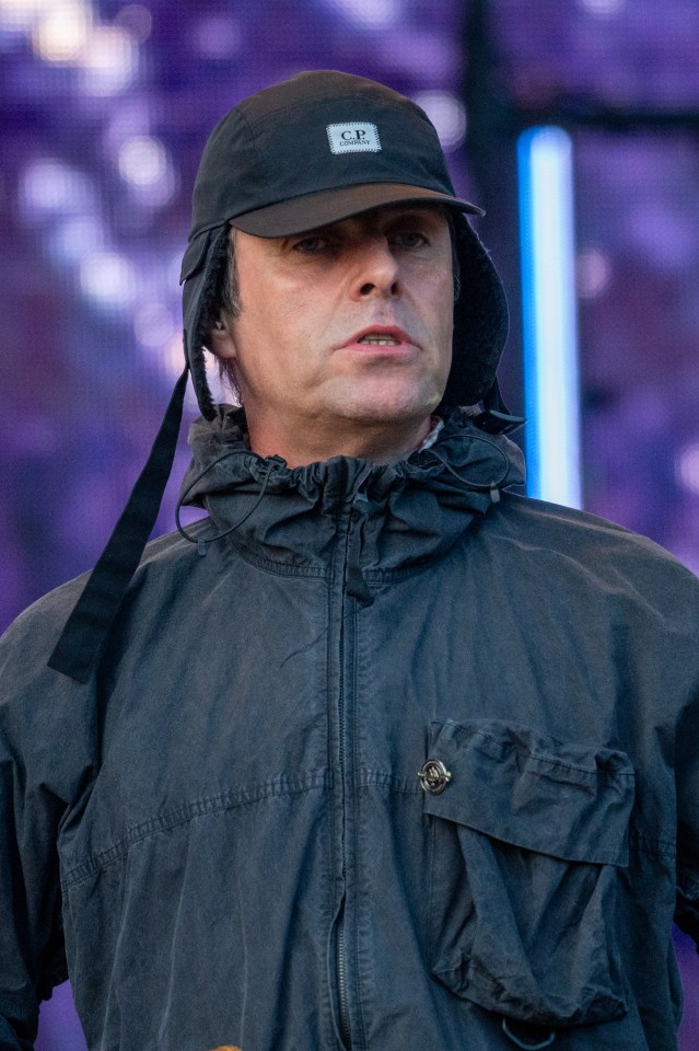 a man wearing a black c.p. hat and a black jacket